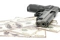 Close up image of pistol and dollar .