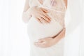 Close-up image of pregnant woman touching her belly with hands Royalty Free Stock Photo