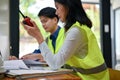 Close-up image of a professional Asian female engineer using a walkie-talkie to monitor her team Royalty Free Stock Photo