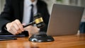 Close-up image of a professional male lawyer holding a judge gavel at his desk