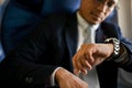 Close-up image, Professional Asian businessman checking his watch for the arrival time Royalty Free Stock Photo