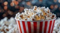 Close up image of a red and white striped popcorn cup