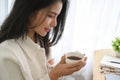 Close-up image, Relaxed Asian young woman with a cup of coffee