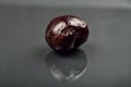 Close up of image of rotten red cherry fruit on reflective black Royalty Free Stock Photo