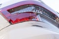 Close up image of scratches on rear bumper of white car and broken rear lamp. Royalty Free Stock Photo