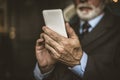 Close up image of senior businessman using smart phone. Royalty Free Stock Photo