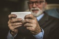 Close up image senior men using mobile phone. Focus on hand. Royalty Free Stock Photo