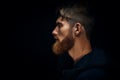 Close-up image of serious brutal bearded man on dark background