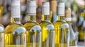 A close-up image of several glass bottles of white wine lined up Royalty Free Stock Photo