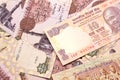 A close up image of an India rupee note on a background of Egyptian pound notes