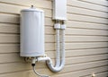 Vertical White PVC Vent Pipe for Tankless Water Heater Outdoor Discharge System Royalty Free Stock Photo