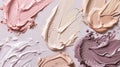 A close-up image showing several shades of foundation makeup swirled on a white background Royalty Free Stock Photo
