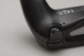 Close up of black game controller rear trigger button and grip isolated on neutral background for gaming hardware and console use Royalty Free Stock Photo