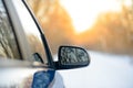 Close up Image of Side Rear-view Mirror on a Car in the Winter Landscape with Evening Sun Royalty Free Stock Photo