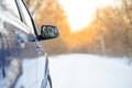 Close up Image of Side Rear-view Mirror on a Car in the Winter Landscape with Evening Sun Royalty Free Stock Photo