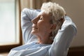 Closeup view mature woman resting on couch enjoy fresh air