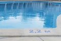 close up image of signs of depth in meters in swimming pool, deep pool with blue water, no people around, Royalty Free Stock Photo