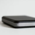 A close-up image of a sleek, black external hard drive with a compact rectangular