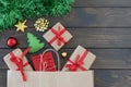 Close up image of small gift boxes tired with ribbon, new year balls, green tinsel on wooden background, copyspace for text. Royalty Free Stock Photo