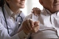 Closeup cropped image nurse holding hand of old man patient