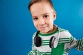 Close up image of smiling young boy posing with headphone Royalty Free Stock Photo