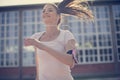 Close up image of smiling young woman running.