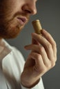Close up image of sommelier examining smell of wine cork