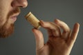Close up image of sommelier examining smell of wine cork