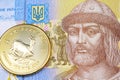 A Ukranian one hryvnia bank note with a gold Krugerrand Royalty Free Stock Photo