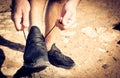 Close up image of sportsman tying shoes. Royalty Free Stock Photo