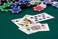 A close up image of stacked poker chips and a royal flush. Royalty Free Stock Photo