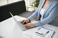 Close-up image of a successful senior businesswoman using laptop, typing on keyboard Royalty Free Stock Photo