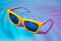 Close-up image of sunglasses on turquoise blue background with palm tree shadow Royalty Free Stock Photo