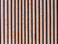 Image of surface of a wall of corrugated roof. Rusty metal