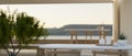 Close-up image of a table in a modern, minimal spacious cafe lounge with an amazing nature view