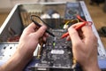 Technician repairing a broken computer in a workshop, close-up Royalty Free Stock Photo
