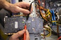 Technician repairing a broken computer in a workshop, close-up Royalty Free Stock Photo