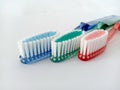 close-up image of three toothbrushes, blue, green and red Royalty Free Stock Photo
