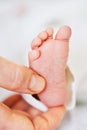Image of tiny newborn baby feet holding by father Royalty Free Stock Photo