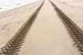 Close up image of tire tracks on the sand beach Royalty Free Stock Photo