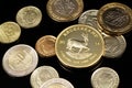 A close up image of Turkish coins and a gold South African one ounce coin on a black background Royalty Free Stock Photo