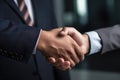 Close-up image of two business people shaking hands in office, Businessman handshake in a close-up shot, top section cropped, with Royalty Free Stock Photo