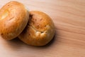 Close up image of two morning breakfast bagel breads with blank space on a wooden background
