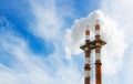 Close up image of two smoke stacks billowing smoke Royalty Free Stock Photo