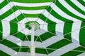 Close up image of underneath green and white striped beach umbrella Royalty Free Stock Photo