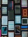 A close-up image of various tablets and e-readers displaying educational materials, showcasing the evolution of digital