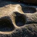 Image of a weathered rock surface featuring multiple rounded Royalty Free Stock Photo