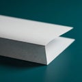 A close-up image of a white envelope with a pointed flap resting on a smooth, teal- Royalty Free Stock Photo