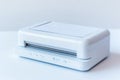 A close-up image of a white printer sitting on a table, ready for use Royalty Free Stock Photo