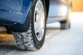 Close-up Image of Winter Car Tire on the Snowy Road. Drive Safe.